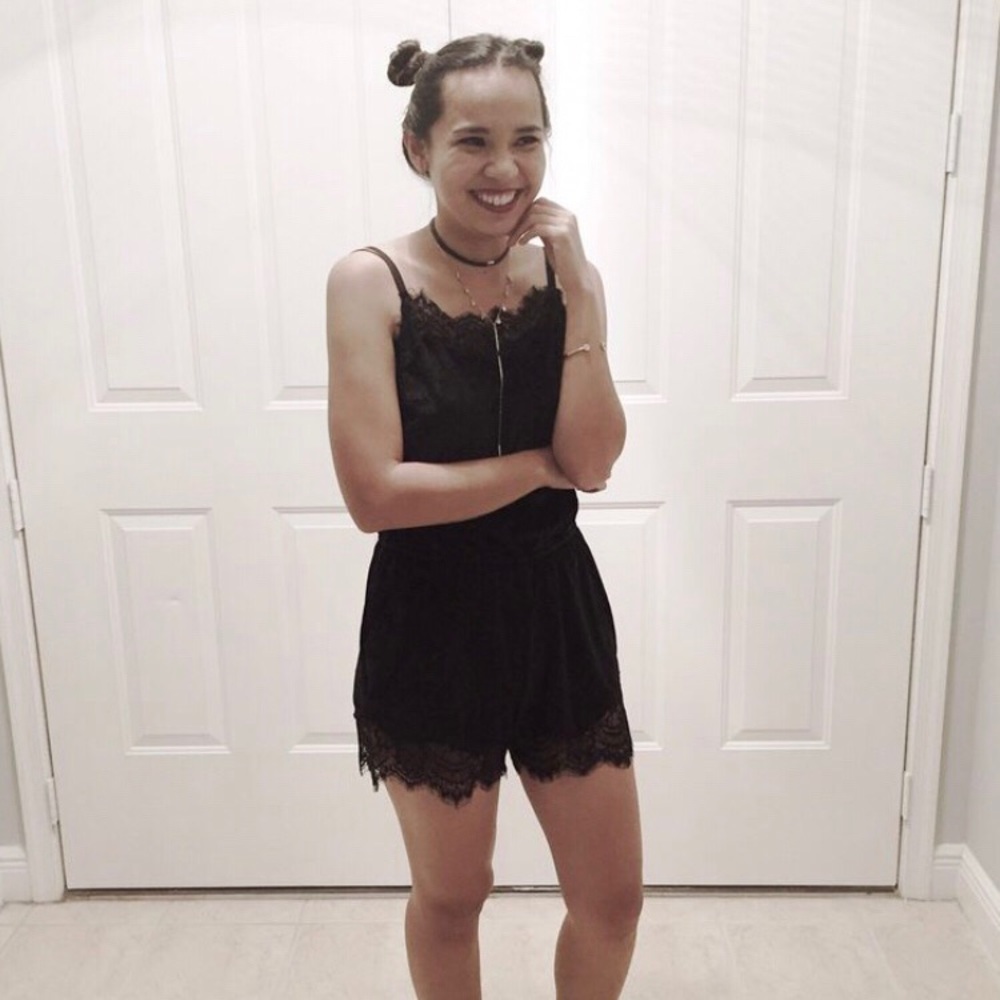 Black velvet romper with lace details.